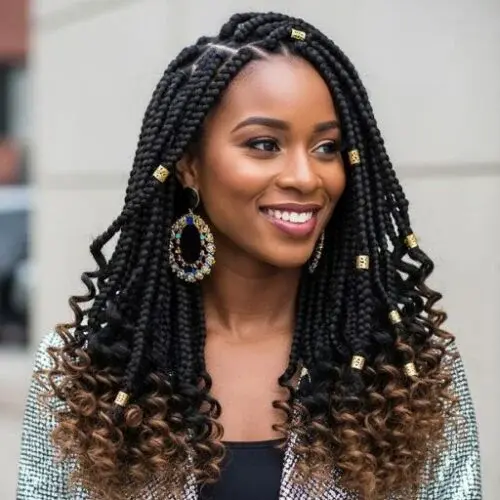 Long boho box braids with curly ends and gold accessories for protective styling