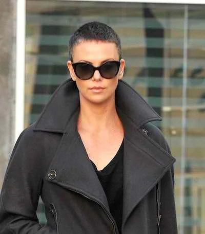 Charlize Theron with her signature buzz cut, a bold celebrity short hairstyle trending in 2025.