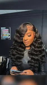 Woman with side parted curly hair, voluminous and face framing curls trending in 2025.