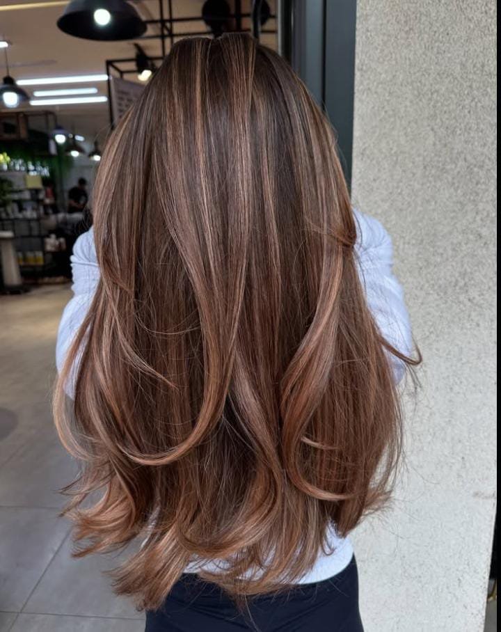 Ultra-long sleek straight hairstyle with shadow root, a trending 2025 look combining glam length with effortless color depth.